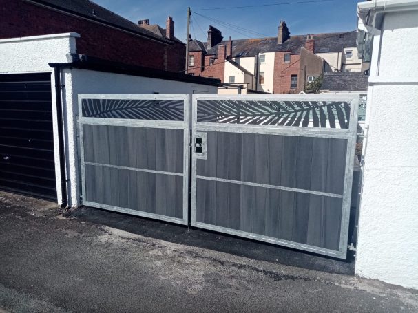 Grey composite drive gates with a galvanized metal frame